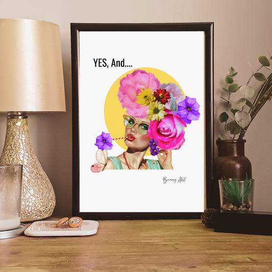 The Sassy Floral 'Yes, And...' Collage Print by The Brummy Artist UK showcases a framed vintage-inspired portrait of a person wearing glasses with flowers and butterflies adorning their head. The artwork features the text "YES, And..." and serves as a perfect retro collage print to accompany decor items on your table.